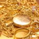 Scattered gold jewelry and accessories
