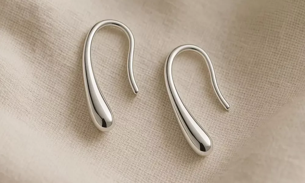 Close-up of a model wearing stylish silver drop earrings showcasing the latest jewelry trends