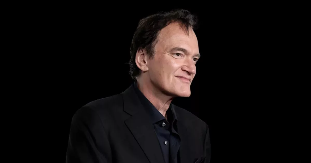 Man in black suit, serious expression.